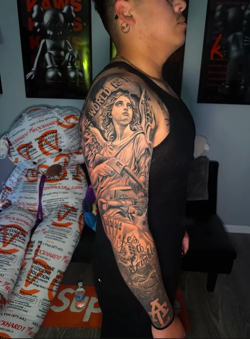 Large-scale black and grey realism sleeve with a classical portrait by Hasan Ink