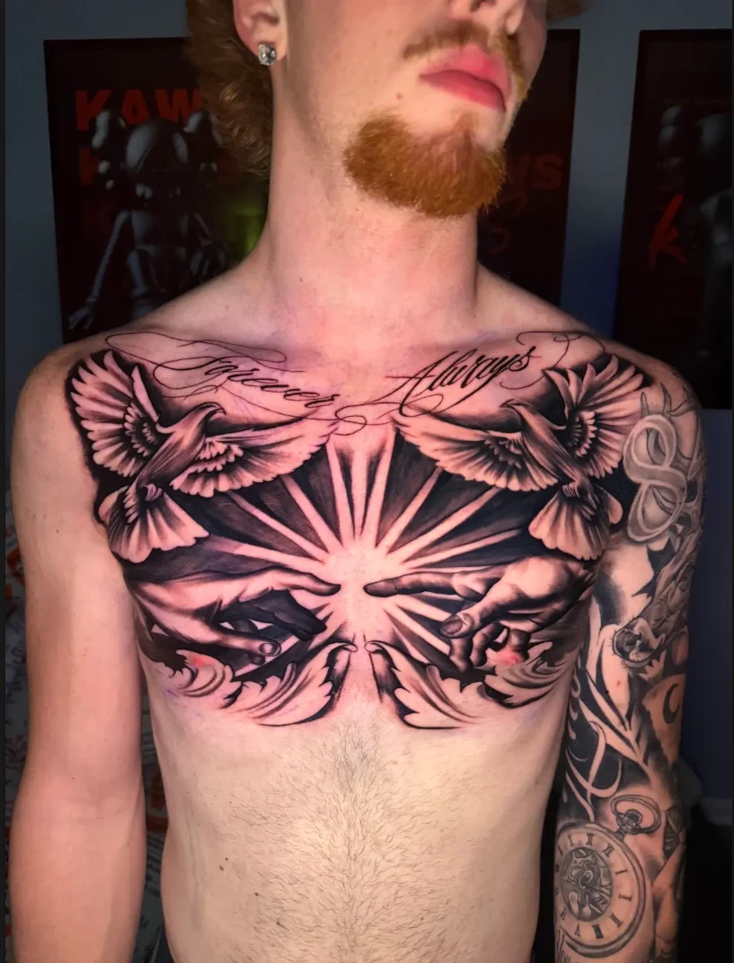 Symmetrical bird and sunburst chest tattoo by Therapeutic Tats