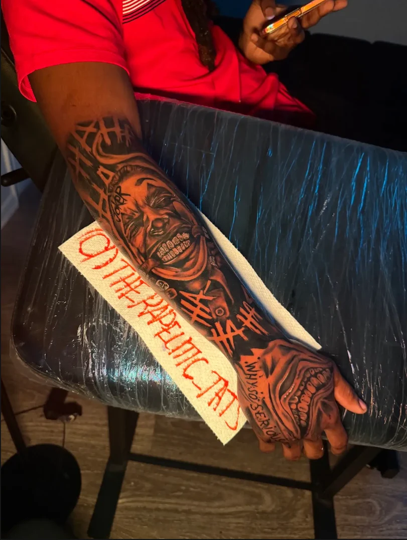 Black and grey face and rose forearm tattoo by Hasan Ink