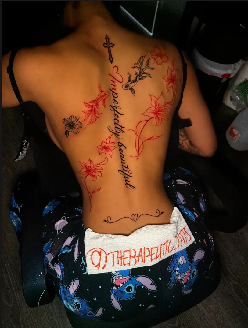 Floral and flowing script back tattoo by Therapeutic Tats in Summerville